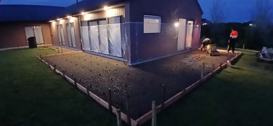 Concrete path boxing set out around a new home at dusk in the Manawatū