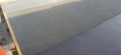 Exposed aggregate concrete driveway with a timber boxing edge in Palmerston North