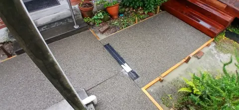 Exposed aggregate concrete path with a drain channel in Palmerston North