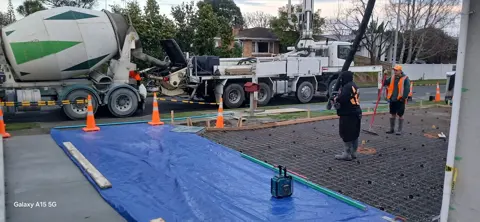 Concrete truck and pump on a driveway pour in Palmerston North